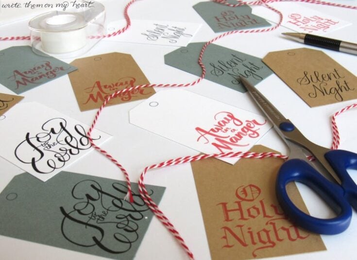 Colorful gift tags with festive messages for Christmas, surrounded by scissors, twine, and craft supplies, emphasizing holiday gift wrapping and decoration ideas.