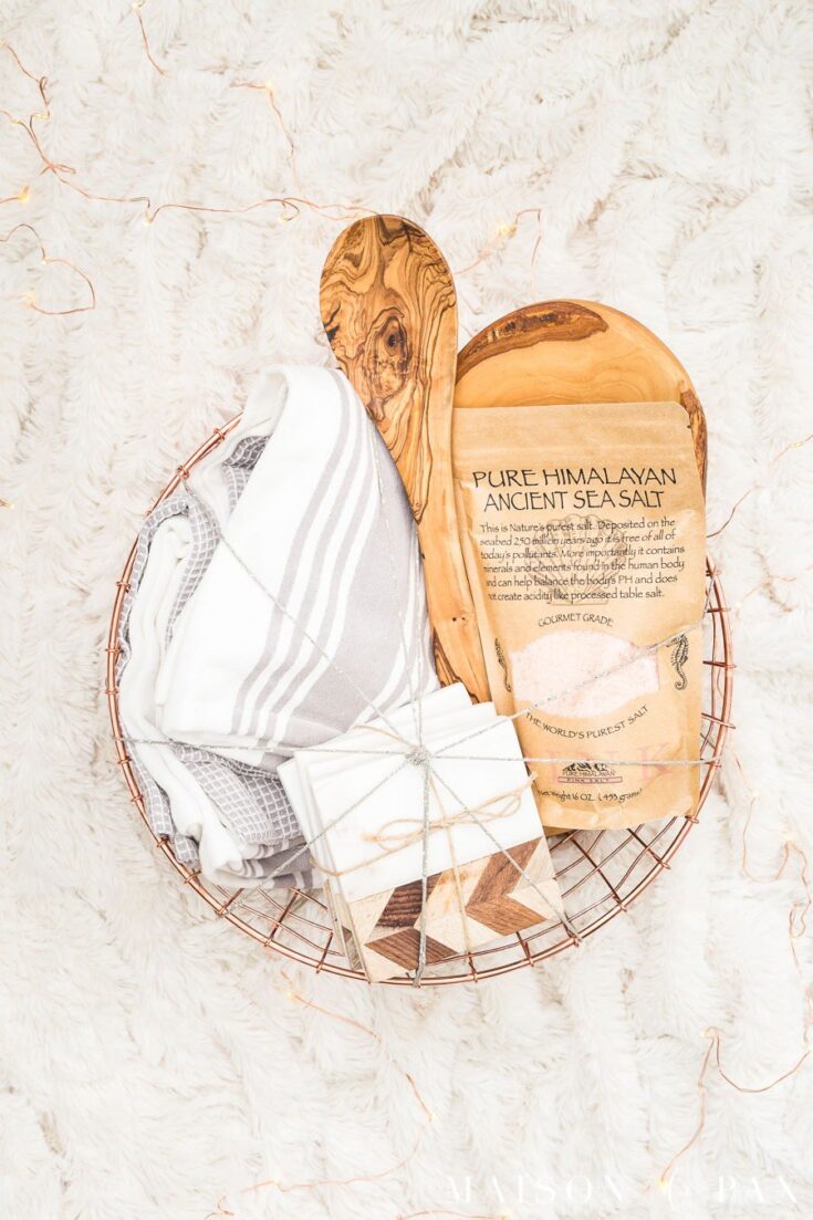 Natural Himalayan sea salt in eco-friendly packaging with essentials for wellness, presented in a rustic wooden tray with soft cozy textiles, perfect for self-care routines.