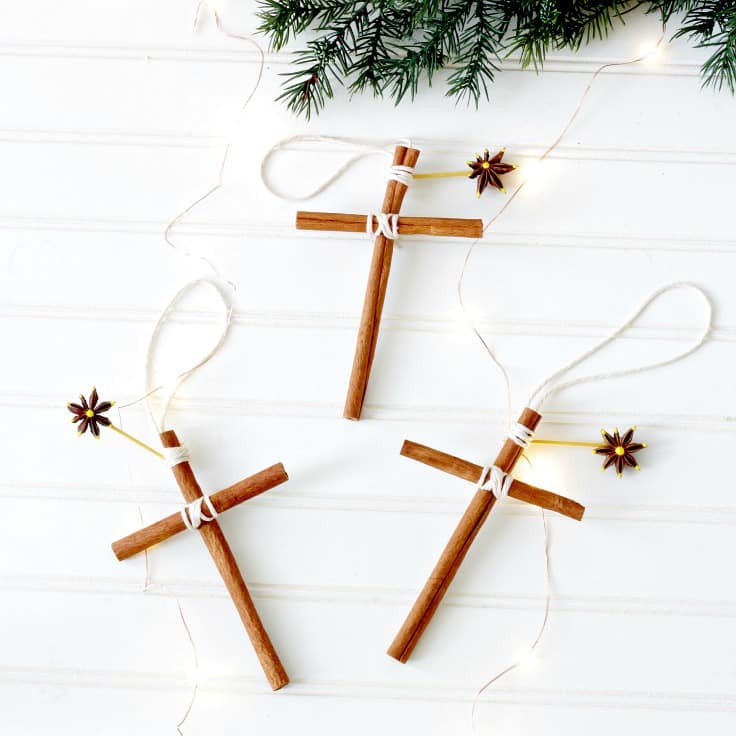 Handmade cinnamon cross ornaments for Christmas decorations, with dried star anise and greenery, creating a festive and aromatic holiday garland.
