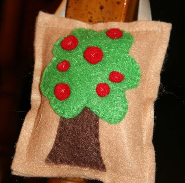 Bright felt tree applique on burlap fabric, perfect for rustic or holiday decor, handmade crafts, and DIY gift embellishments.