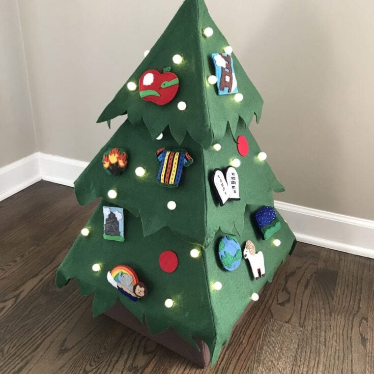 Colorful DIY felt Christmas tree with LED string lights and diverse themed decorations, including animals, nature, and travel motifs, created for a festive, handcrafted holiday display.