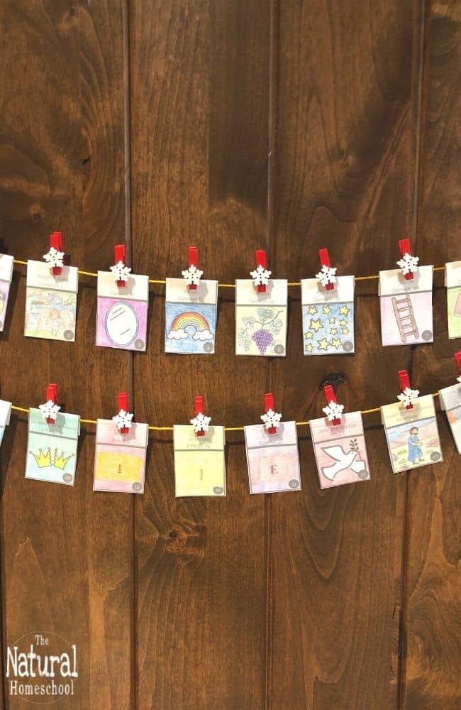 Colorful handmade classroom decorations on a string, featuring artistic drawings and motivational symbols for homeschooling and educational inspiration.