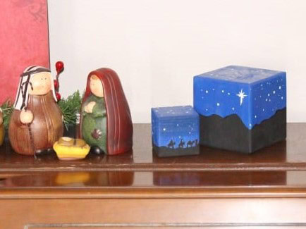 Colorful Christmas nativity figurines and decorative boxes with starry night design, perfect for holiday home decor and festive celebrations.