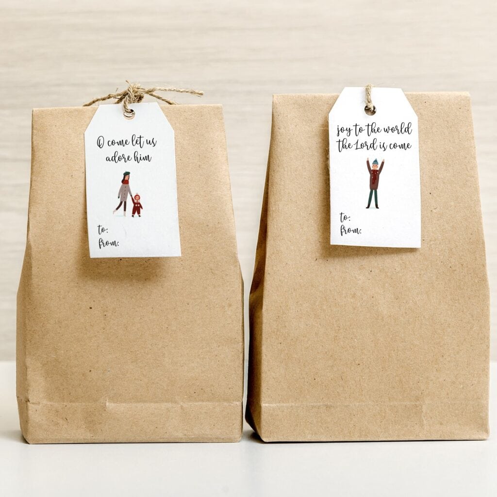 Handmade gift bags with Christmas-themed tags featuring religious sentiments, perfect for holiday gift-giving, from A Hundred Affections.