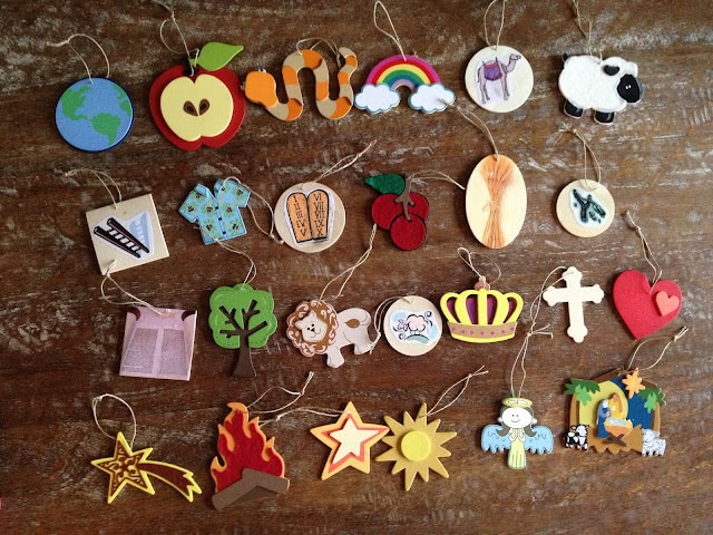 Colorful wooden and felt ornaments with nature, animals, and whimsical designs on rustic wood background for boho nursery decor and wall hangings.