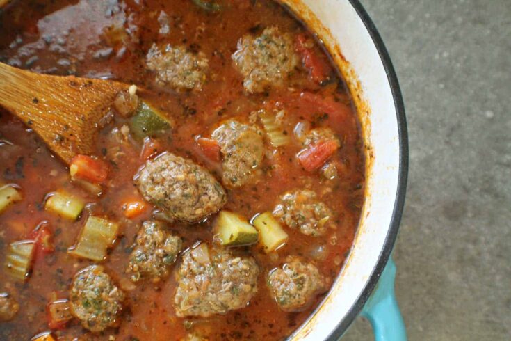 Savory homemade meatball soup with vegetables in a pot, highlighting comforting and hearty meal options for family dinner ideas.