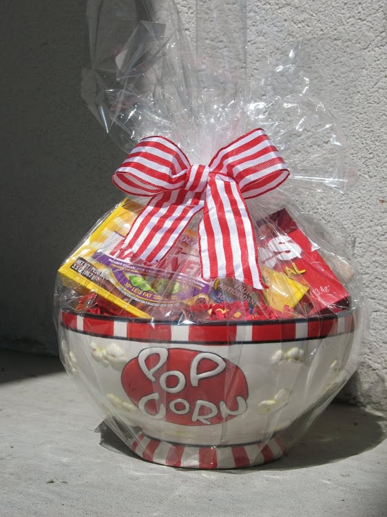 Sweet Valentine’s Day candy gift basket with Reese's and Skittles, wrapped in clear cellophane with a red-and-white striped bow, perfect for expressing love and affection.