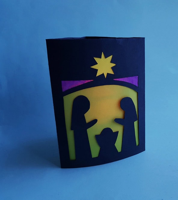 Families nativity scene paper craft with colorful silhouettes and star, handmade Christmas craft, holiday decorations, festive paper art for Christmas season.