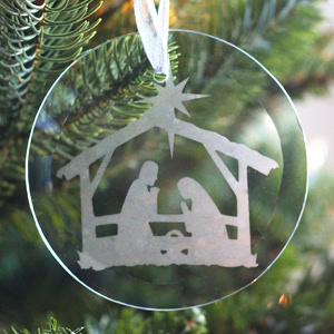 Ornamental acrylic Christmas nativity scene ornament hanging on a Christmas tree, featuring a silhouette of Mary, Joseph, and baby Jesus under a shining star, perfect for holiday decor and religious celebrations.