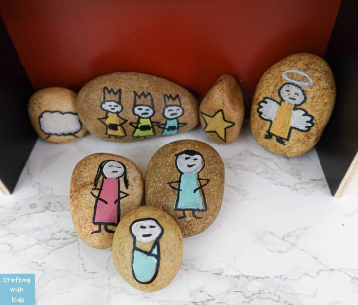 Hand-painted rock art depicting children and angels for kids' crafts, colorful and creative stone painting perfect for DIY kids' activities.