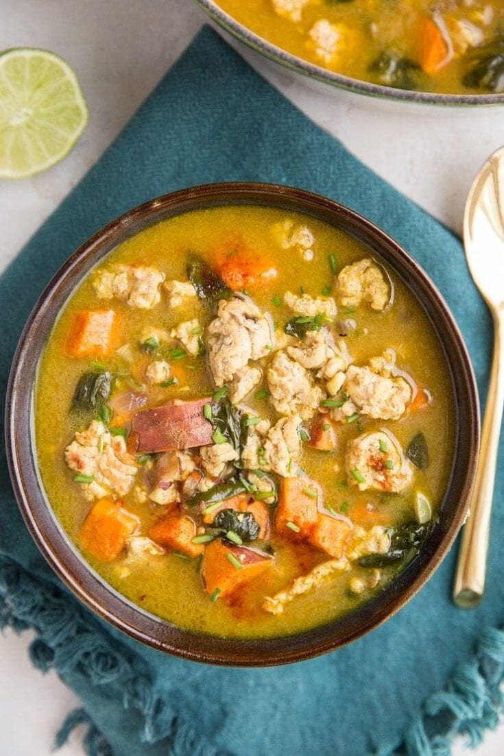 Hearty chicken and vegetable soup with fresh herbs in a rustic bowl, perfect for cozy meals and nourishing comfort food.