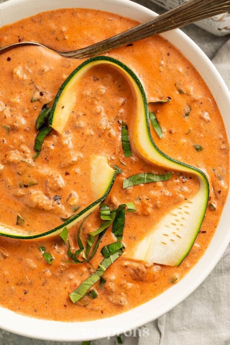 Creamy zucchini and beef stew in a savory tomato sauce garnished with fresh green onions. Perfect comfort food recipe from A Hundred Affections for easy weeknight dinners.