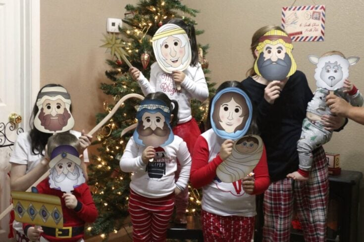 Colorful family celebrating Christmas with nativity mask costumes in front of decorated Christmas tree, creating joyful holiday memories, festive spirit, and holiday traditions.