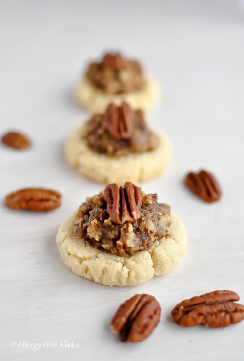 Soft-baked gluten-free cookies topped with pecans and caramelized pecan bits, perfect for sweet cravings and cookie lovers.