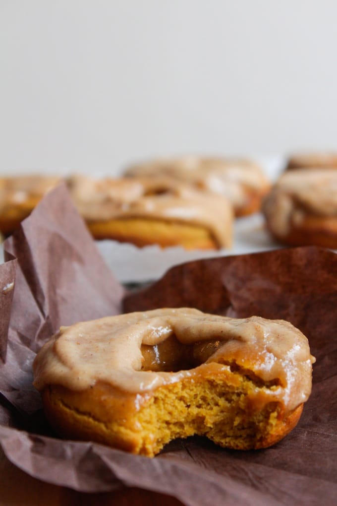 Butter and glaze donut with caramel glaze, close-up shot, bakery style, delicious dessert, sweet pastry, fresh baked donuts, frosting, treat, homemade baked goods, cozy bakery atmosphere, golden-brown donut, indulgent snack, seasonal bakery items, autumn treats, comforting sweets, A Hundred Affections.