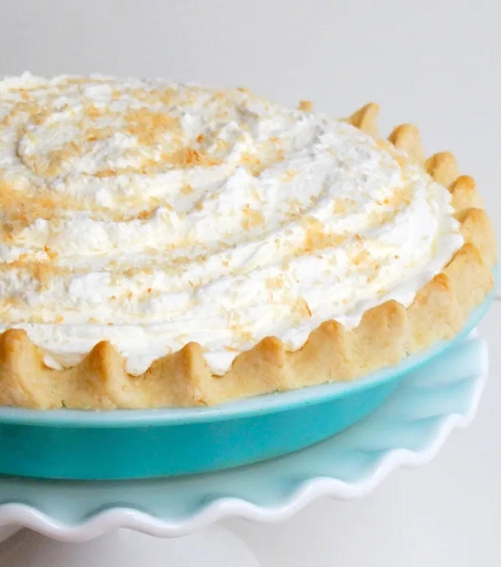Creamy lemon meringue pie with fluffy whipped topping and golden crust, perfect for dessert or special occasions.