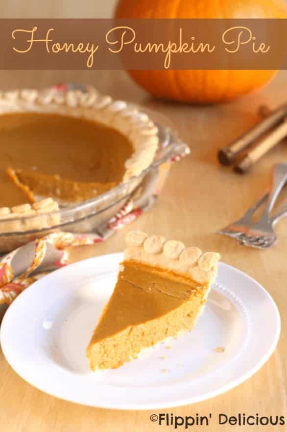 Golden pumpkin pie slice with whipped cream border, served on a white plate, ready to enjoy during fall or Thanksgiving celebrations.