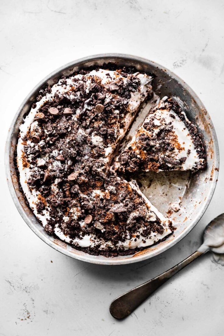 Decadent chocolate cream pie topped with crushed cookies and chocolate chips, perfect for dessert lovers and special occasions.