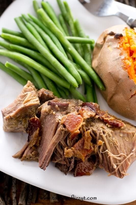 Tender slow-cooked beef with carrots served with fresh green beans and a baked sweet potato, perfect for comforting home-cooked meals and family dinners.