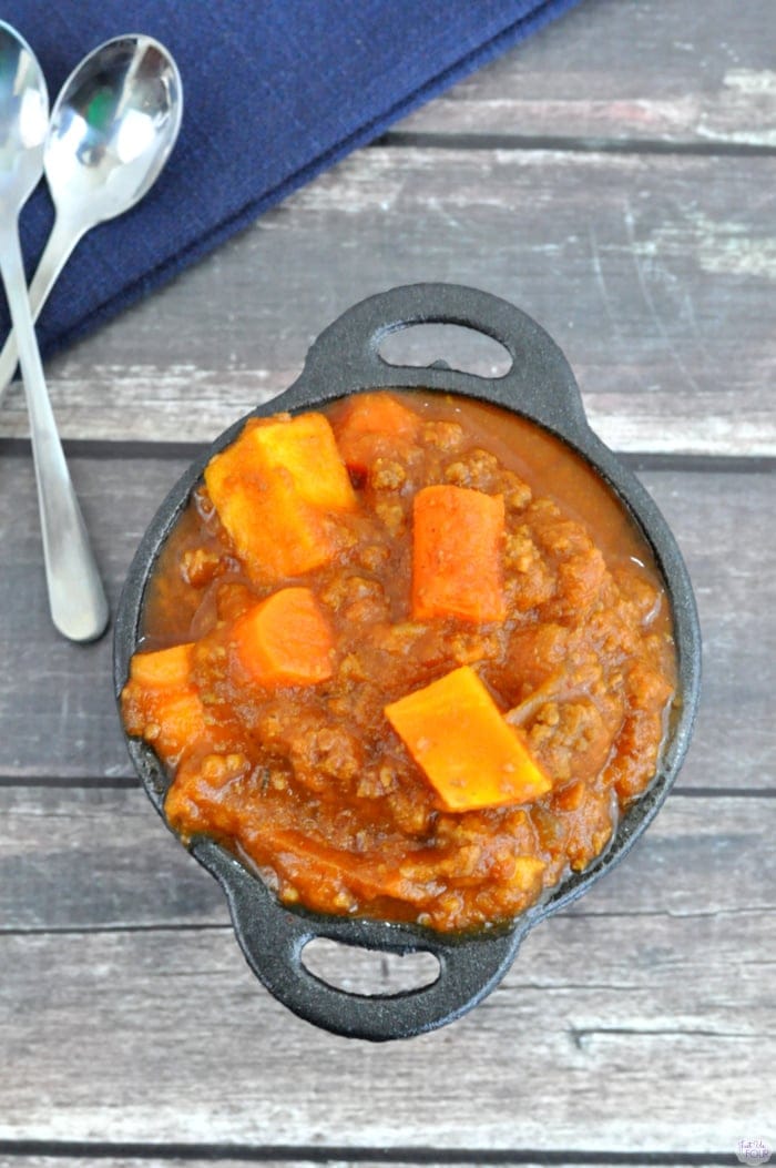 Beef and sweet potato stew served in a small cast iron skillet, featuring hearty meat and tender sweet potatoes, perfect for comforting family meals.
