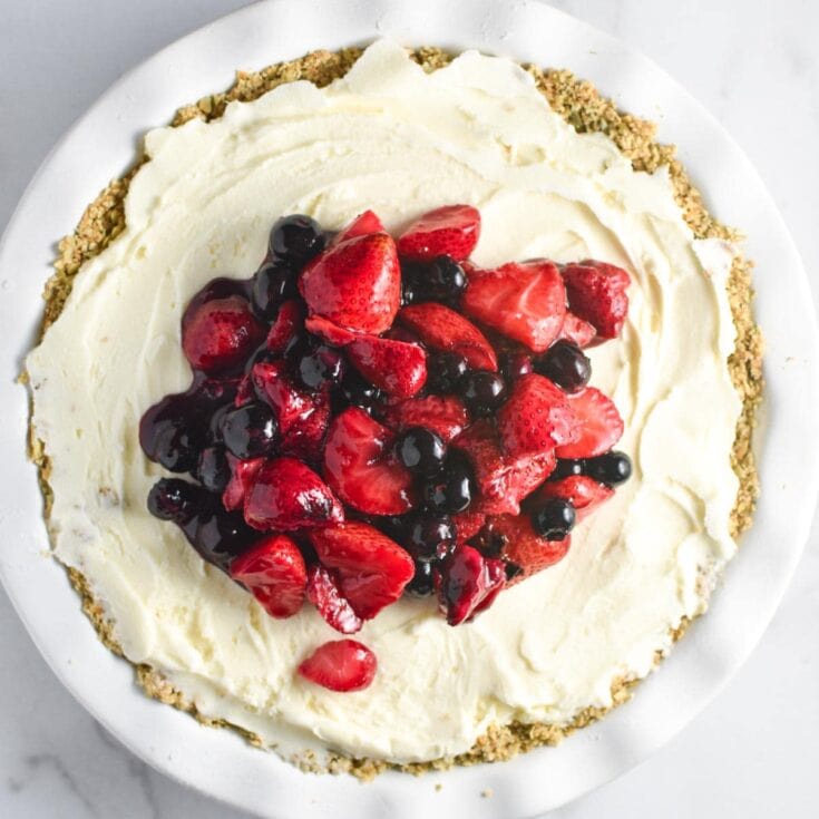 Fresh berry cheesecake topped with mixed strawberries and blueberries on a creamy, smooth, and decadent crust, perfect for dessert lovers and special occasions.