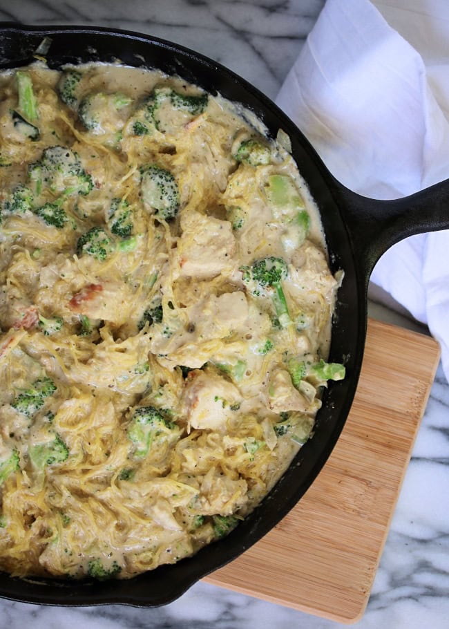 Creamy chicken and broccoli casserole in a cast iron skillet, served with fresh ingredients, perfect for family dinners and comfort food recipes.