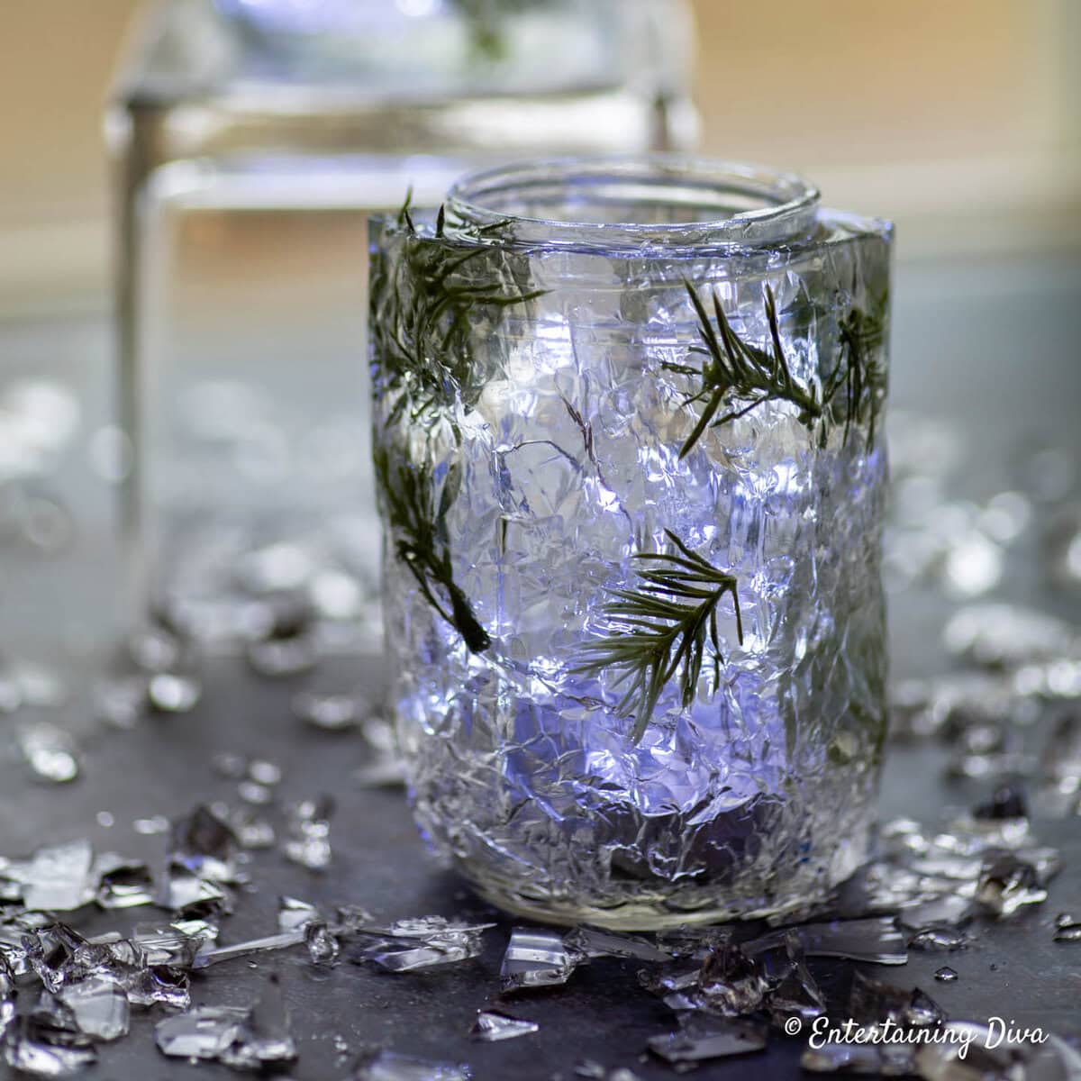Sparkling glass jar with fairy lights and rosemary, elegant home decor for events, cozy ambiance, and rustic interior styling.