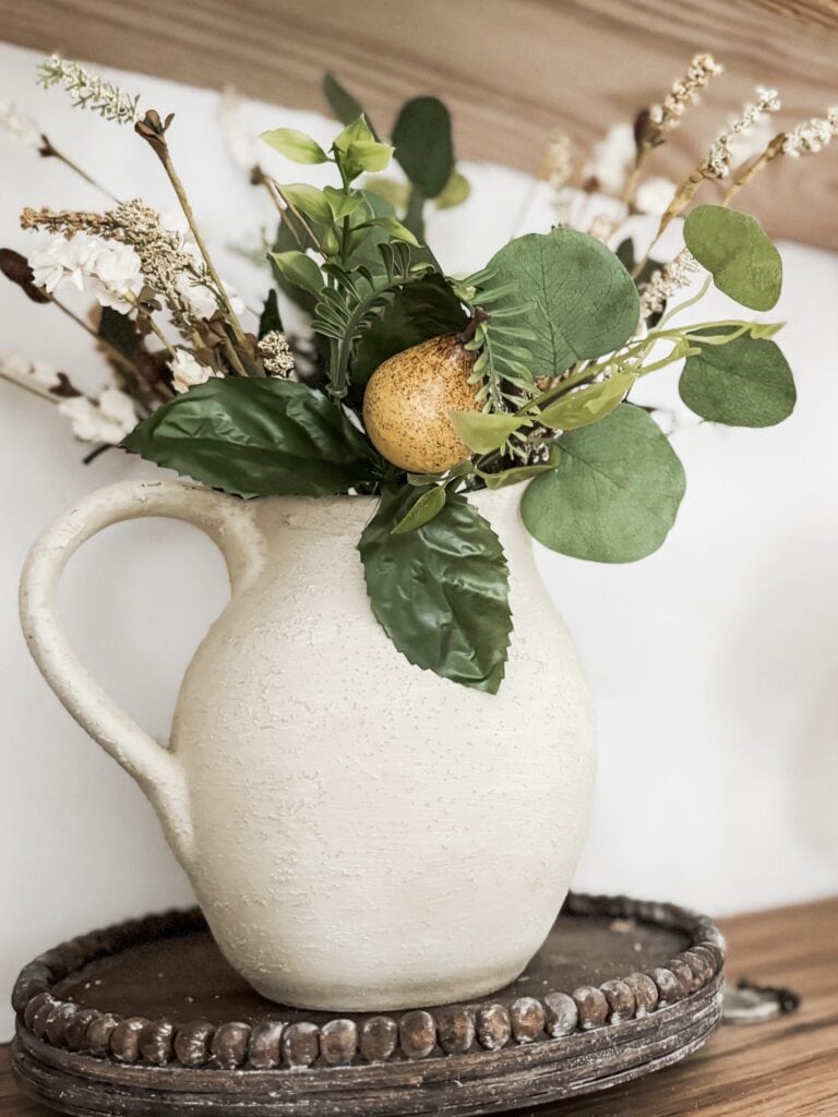 pear stems in a rustic pitcher