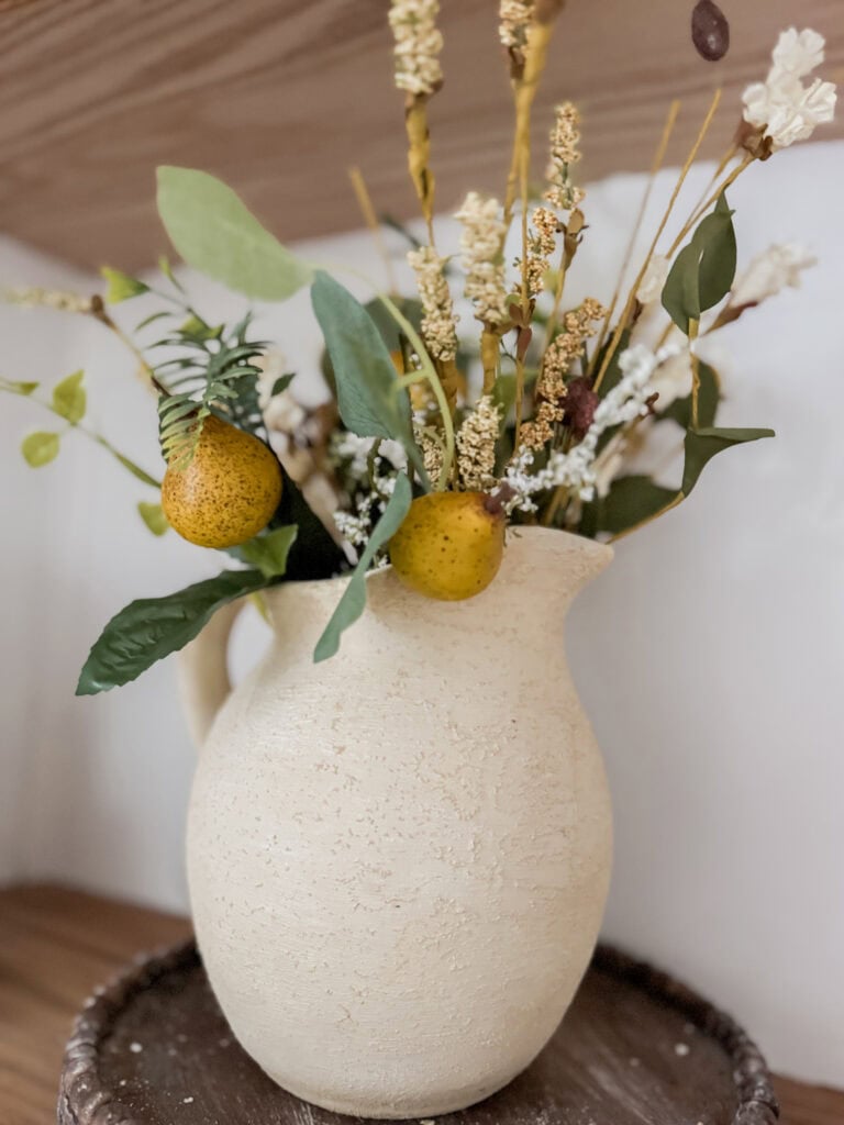 pear stems in a rustic pitcher