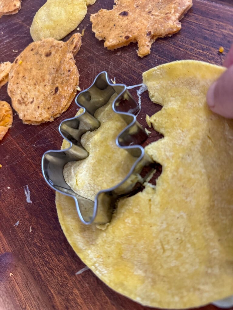 Cookie cutter shaping cookie dough, baking cookies, holiday baking, kitchen baking tools, festive cooking, baking ingredients, cookie preparation, baking for special occasion, home baking,quesadilla