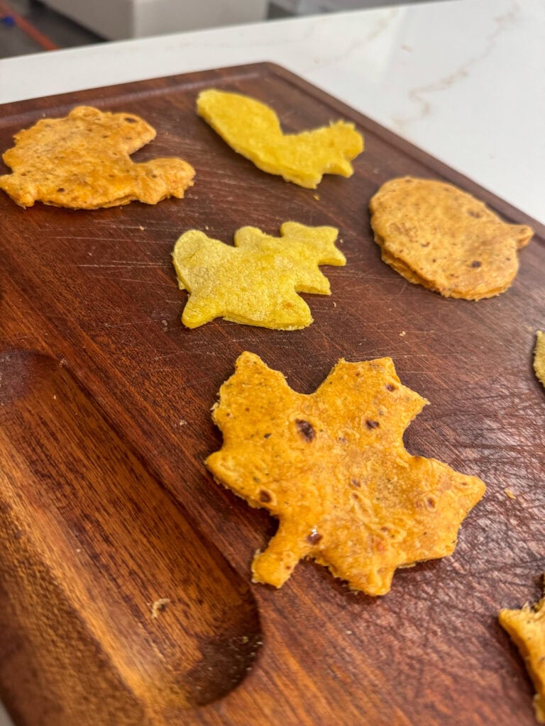 Colorful Indian quesadillas served on a wooden cutting board.