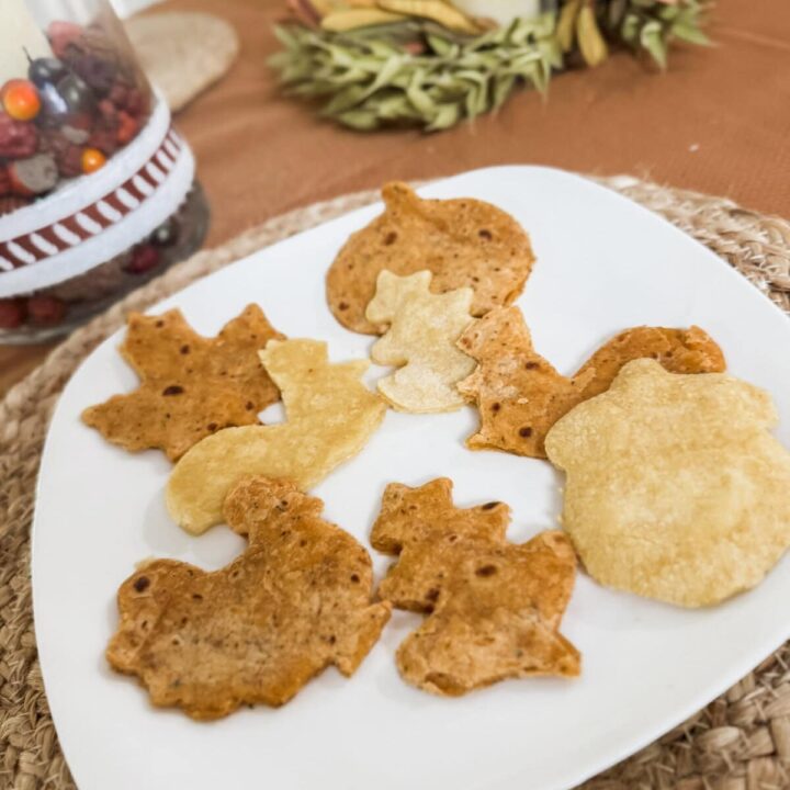 Thin sliced homemade seasoned quesadillas on a white plate, crispy and golden, perfect snack for loved ones.