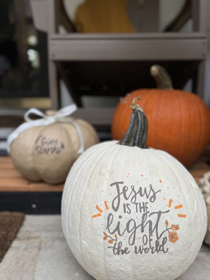 Decorative white pumpkin with inspirational Jesus is the light of the world message, autumn harvest season, fall decor, pumpkin painting, Christian holiday decoration, Thanksgiving centerpiece.