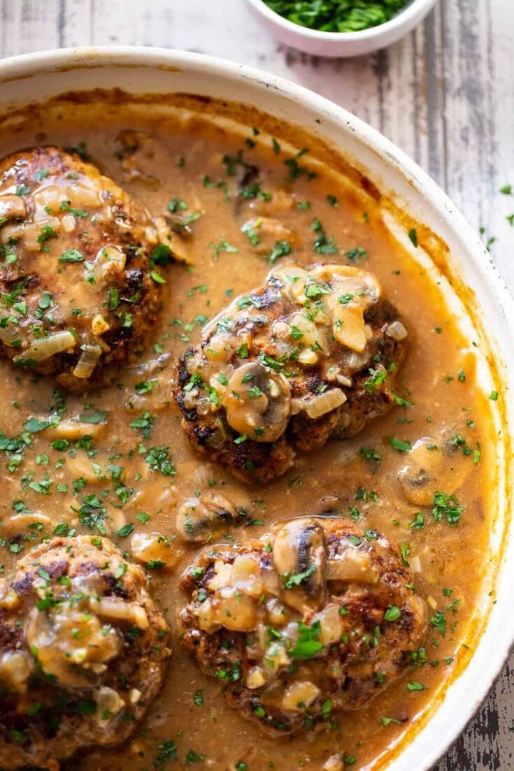 Savory mushroom and onion meatballs in creamy gravy, cooked to perfection and garnished with fresh parsley. Perfect comfort food recipe from A Hundred Affections.