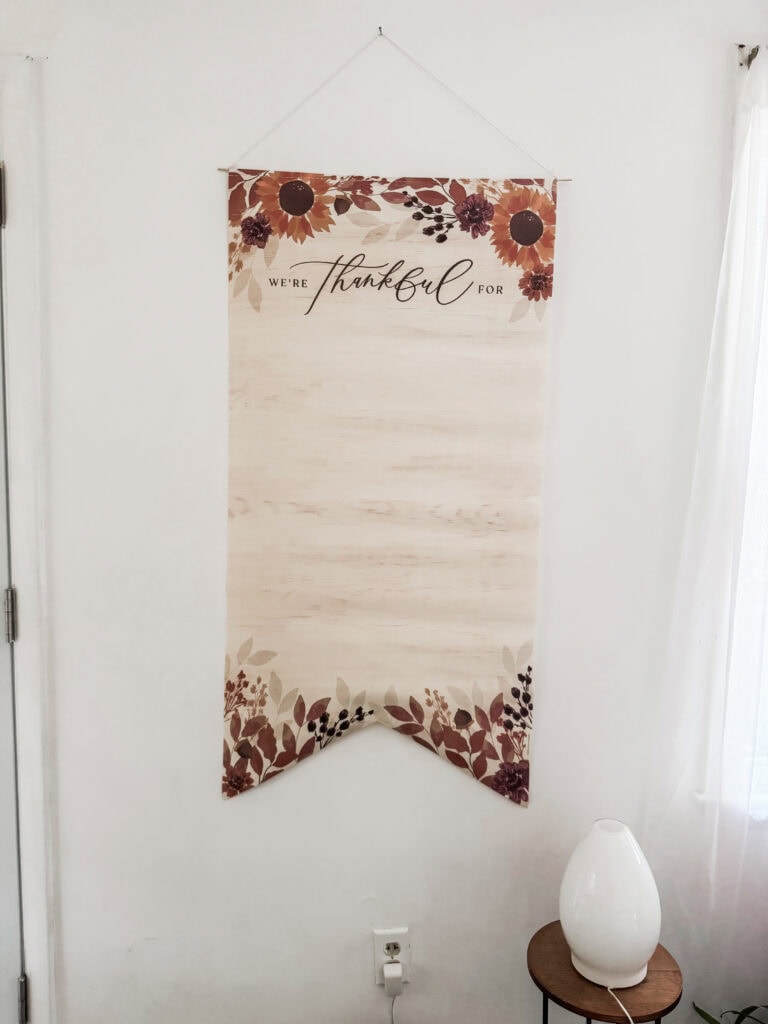 A Hundred Affections thankful wall hanging with floral design and rustic style for home decor and gratitude reminder.