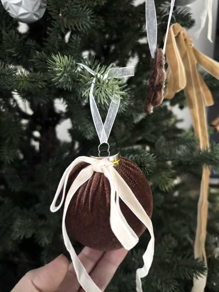 Soft velvet Christmas tree ornament with satin ribbon bows, cozy festive decoration for holiday home decor.