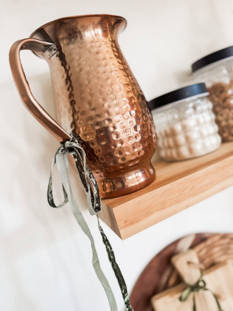 Hammered copper pitcher, vintage style home decor, kitchen or living room accessory, handcrafted metalware, unique household item for rustic or modern interior design.
