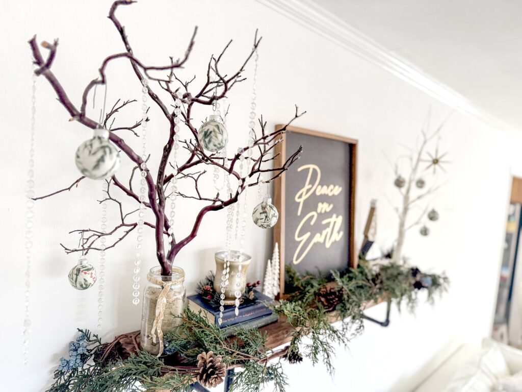 Decorative holiday branches with ornaments and faux foliage for Christmas home decor, rustic seasonal decoration, decorative garland display, festive indoor holiday styling, Christmas mantel decor.