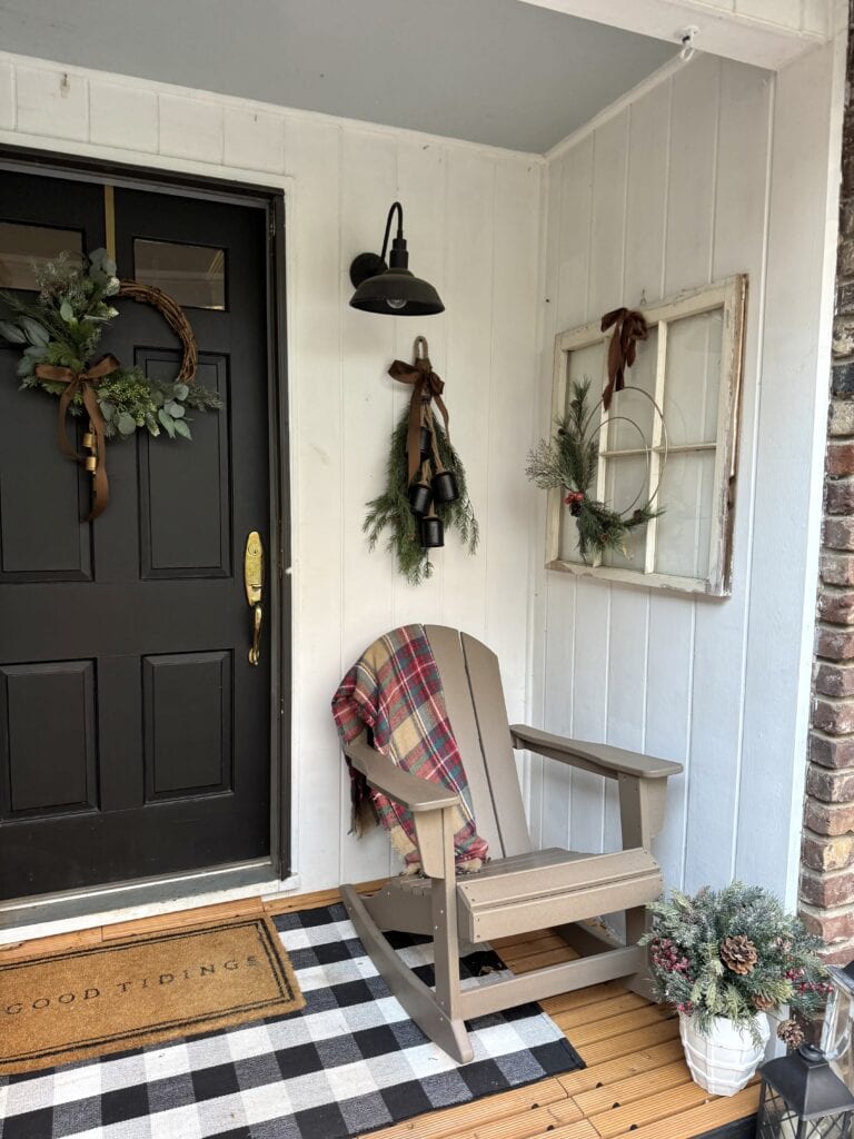 Cozy Christmas porch decor with wreaths, greenery, and festive accents for holiday warmth and charm.