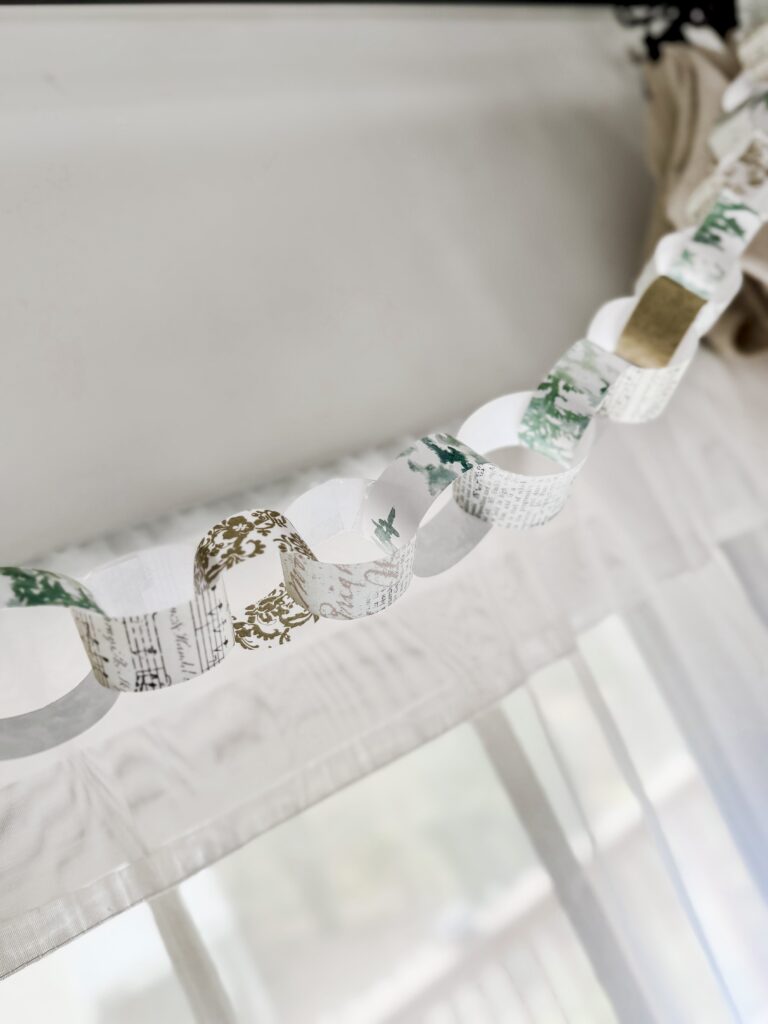 Delicate paper garland with vintage sheet music and botanical print, perfect for wedding or festive decor by A Hundred Affections.