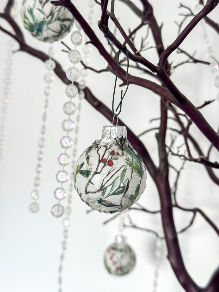 Hand-painted Christmas ornament hanging on a decorative tree with crystal bead garlands, festive holiday decor, handcrafted holiday ornament, winter holiday decoration, Christmas ornament art.