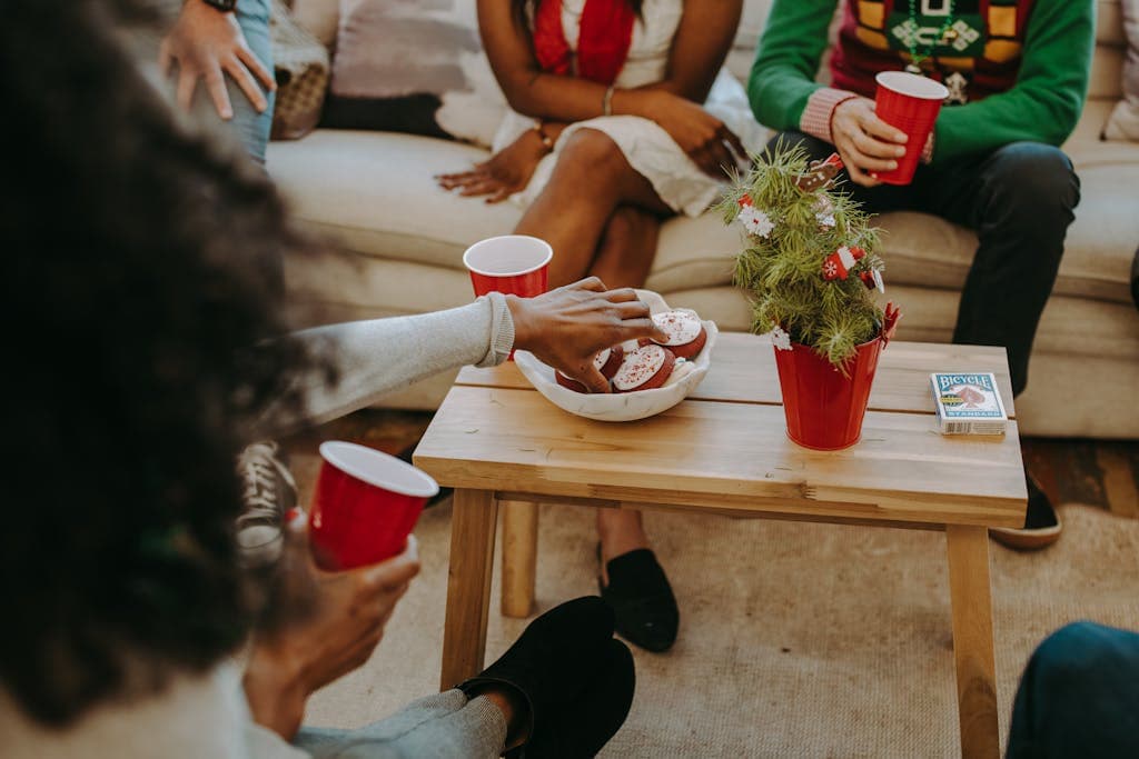 Enjoying Christmas cookies and holiday drinks during a festive gathering with friends at home.