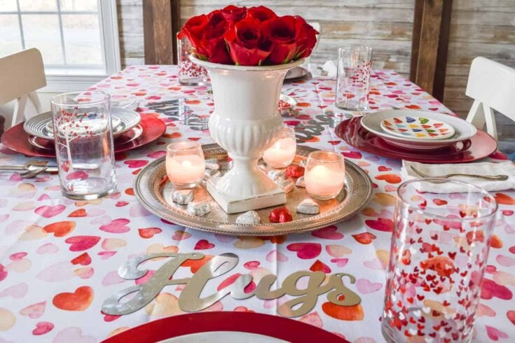 A beautiful Valentine’s Day table decorated with red roses, candles, and heart motifs, perfect for celebrating love and romance at A Hundred Affections.