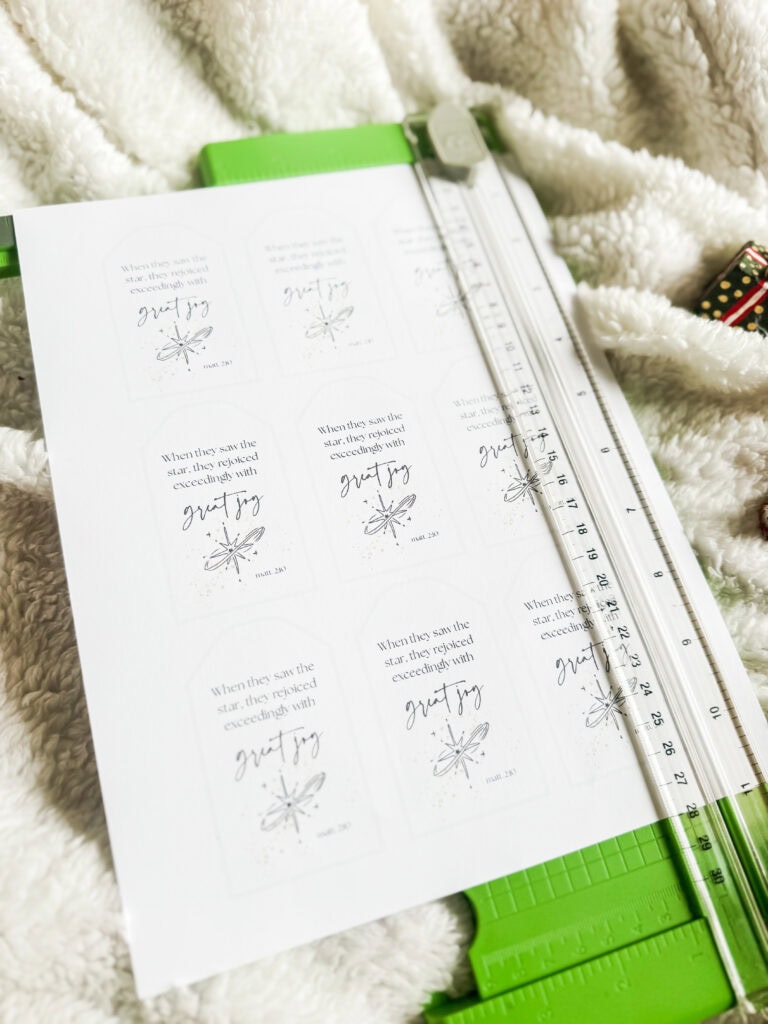 Decorative holiday stickers featuring "great joy", stars, and whimsical designs on festive gift wrapping and craft paper.