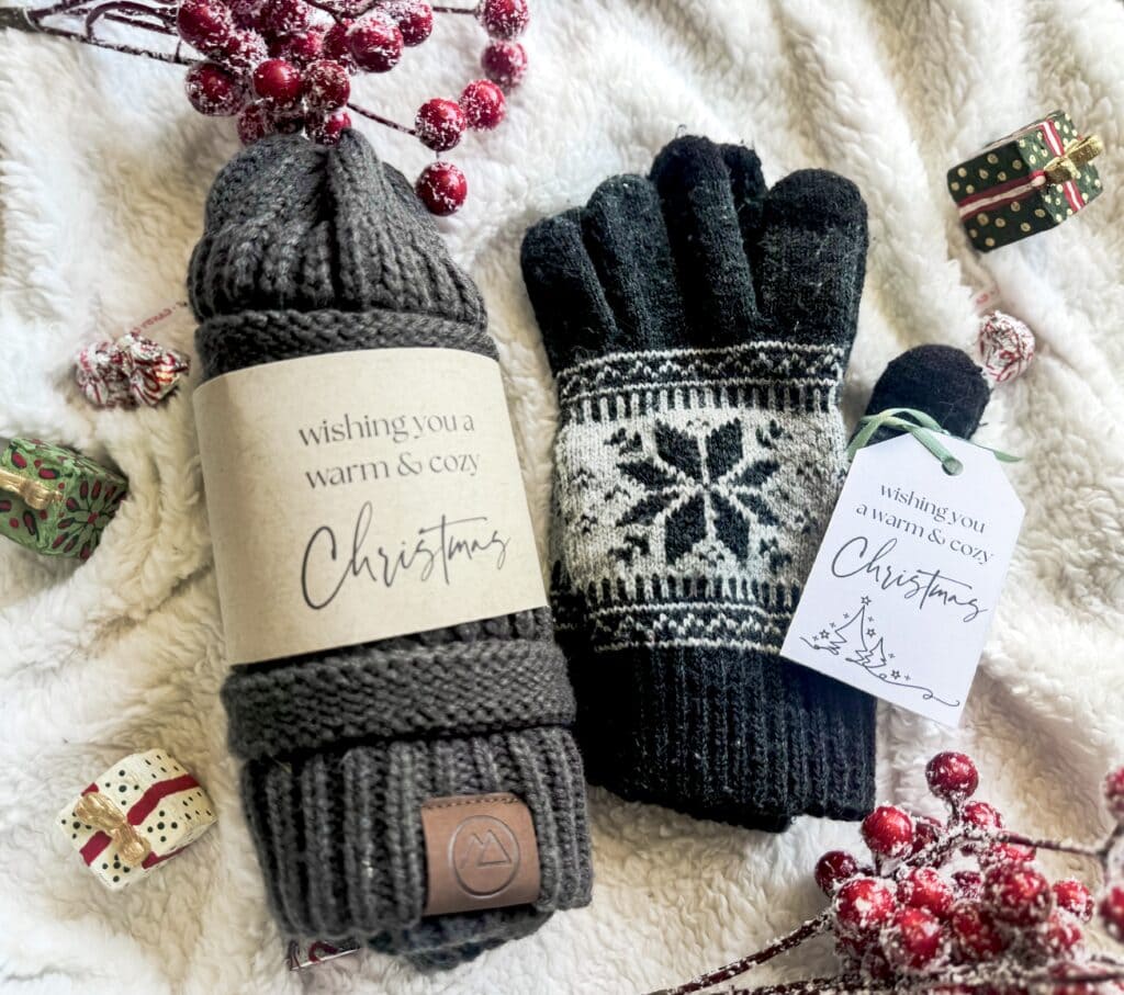 Soft knit grey beanie hat and black winter gloves with snowflake pattern, perfect for Christmas winter warmth and cozy holiday style.