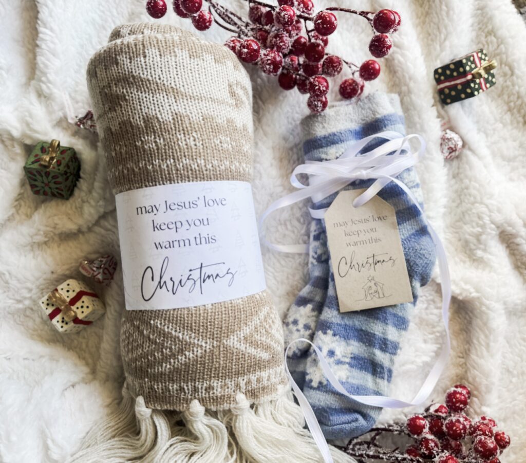 Festive Christmas socks with heartfelt messages, surrounded by mini holiday gift boxes, red berries, and cozy textures for winter holiday cheer.