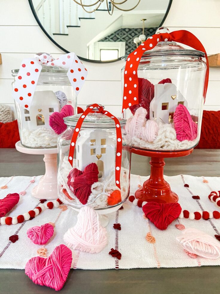 Vase with pink, red, and white yarn hearts, Valentine's Day holiday decor, romantic table centerpiece, craft and DIY love project, charming indoor celebration display.
