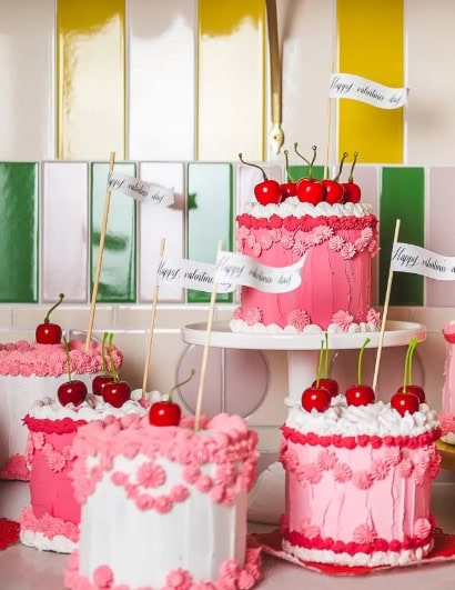 Delicious Valentine’s Day cakes decorated with cherries, pink frosting, and floral accents, perfect for romantic celebrations and special occasions.