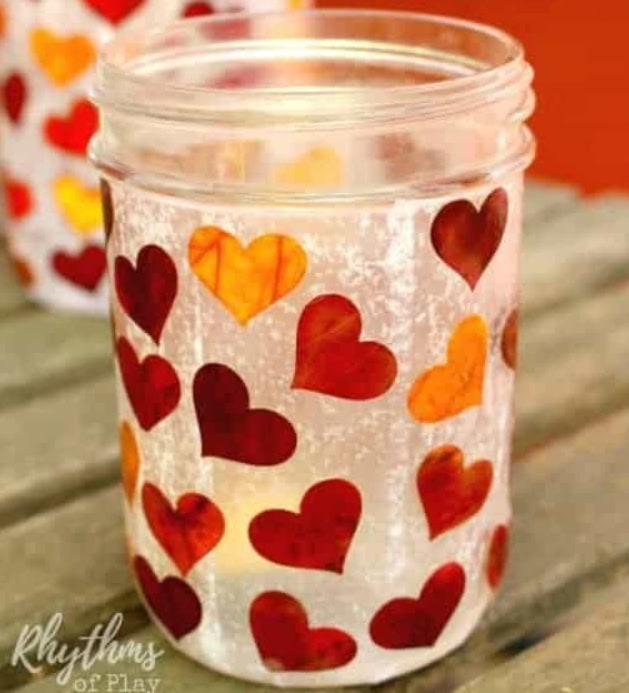 Decorative jar with red and orange hearts, perfect for romantic ambiance and Valentine's Day celebrations. Creates a warm, cozy glow for special moments.
