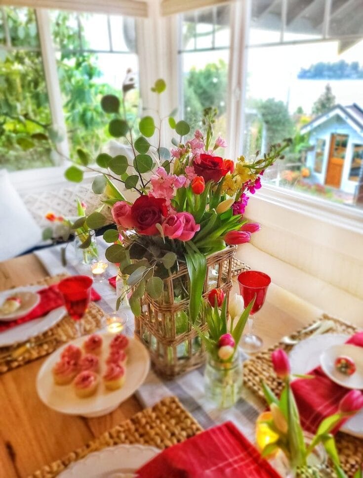 Elegant floral centerpiece with roses, tulips, and greenery for brunch or garden party.